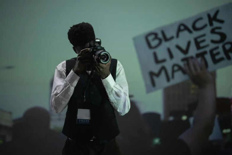 a man taking a picture with a camera, black arts movement, george floyd, jordan matter photography, slide show, thumbnail