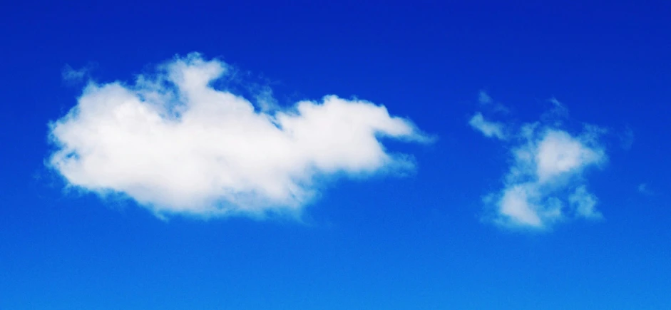 a couple of people riding skis on top of a snow covered slope, an album cover, unsplash, minimalism, giant cumulonimbus cloud, vibrant blue, cloud in the shape of a dragon, cloudless-crear-sky