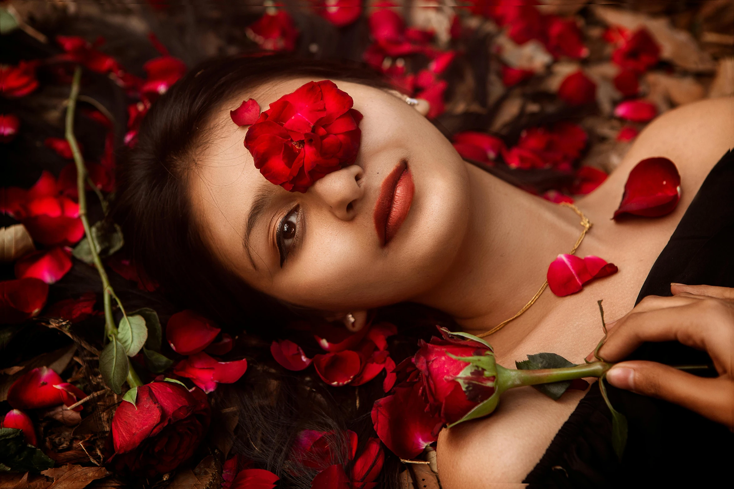 a woman laying on a bed of red roses, by Julia Pishtar, pexels contest winner, beauty woman with detailed faces, assamese aesthetic, 1614572159, romantic themed