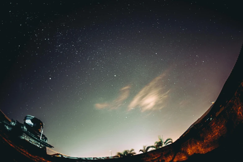 a man riding a skateboard up the side of a ramp, a microscopic photo, pexels contest winner, magical realism, sky full of stars, panorama view of the sky, space ship above an island, sitting on the beach at night