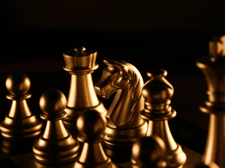 a group of chess pieces sitting on top of a chess board, a bronze sculpture, pexels contest winner, gold suit, up-close, thumbnail, on black background