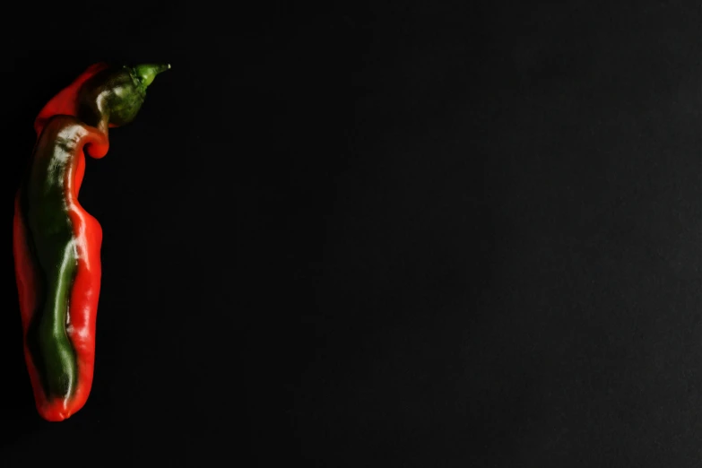 a green and red pepper on a black background, by Lucia Peka, pexels contest winner, banner, tiny person watching, green square, cinematic still