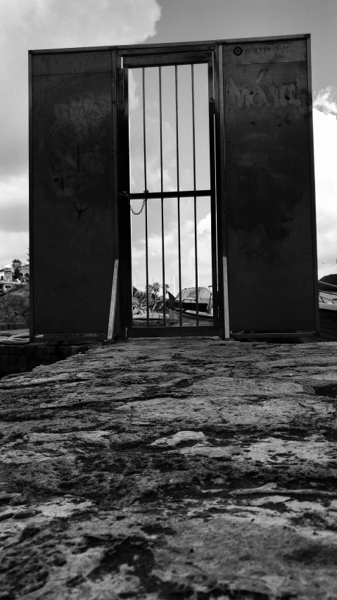 a black and white photo of an open gate, by Kevin Connor, conceptual art, totalitarian prison island, shap, detailed medium format photo, tourist photo