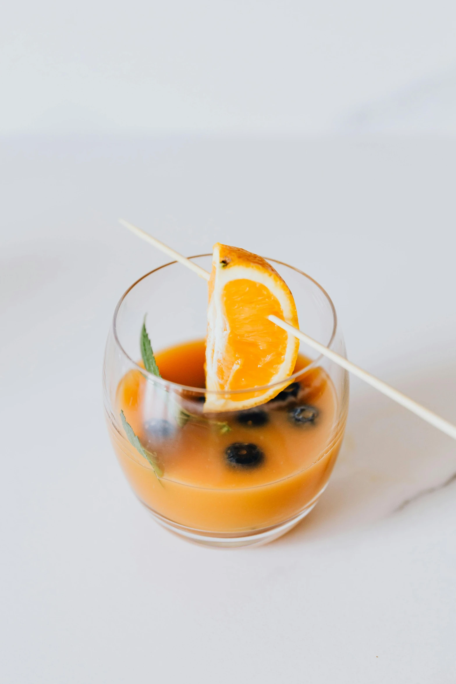 a glass of orange juice with a toothpick sticking out of it, by Ndoc Martini, multiple stories, “berries, cold brew coffee ), thumbnail