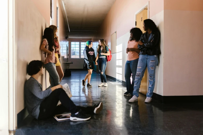 a group of people standing and sitting in a hallway, trending on pexels, ashcan school, teenage girl, fighting, background image, ariel perez