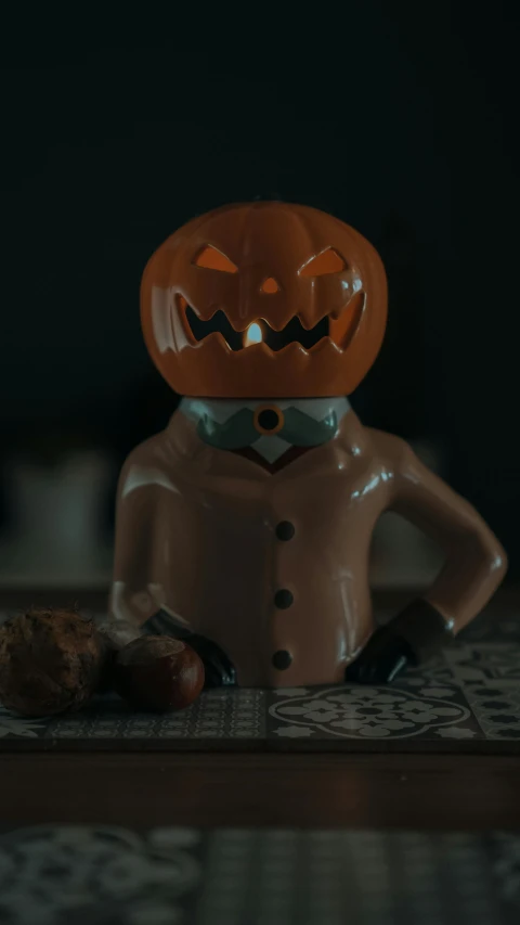 a lego figurine sitting on top of a table, inspired by John Carpenter, pexels contest winner, lowbrow, pumpkins, detailed cinematic render, brown, it's late at night