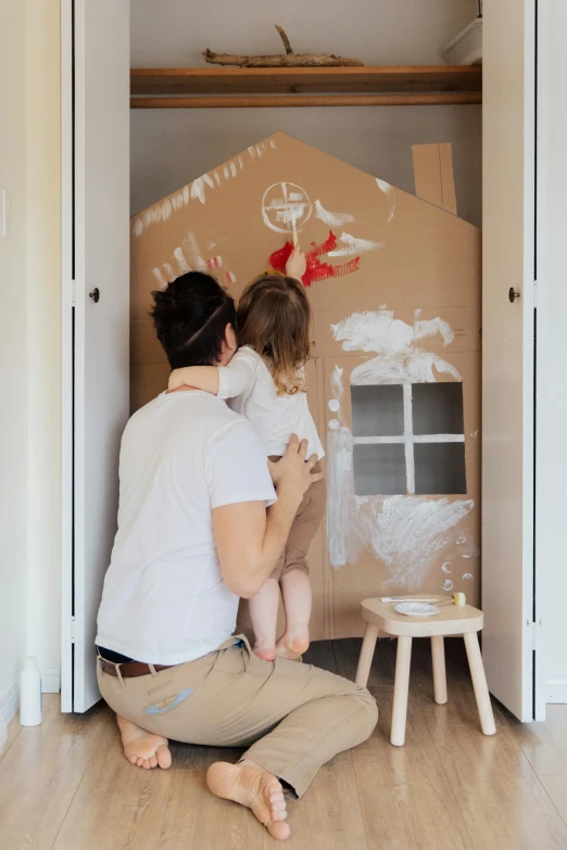 a man and a little girl sitting on the floor in front of a cardboard house, a child's drawing, pexels contest winner, exiting from a wardrobe, white paint, 15081959 21121991 01012000 4k, thumbnail