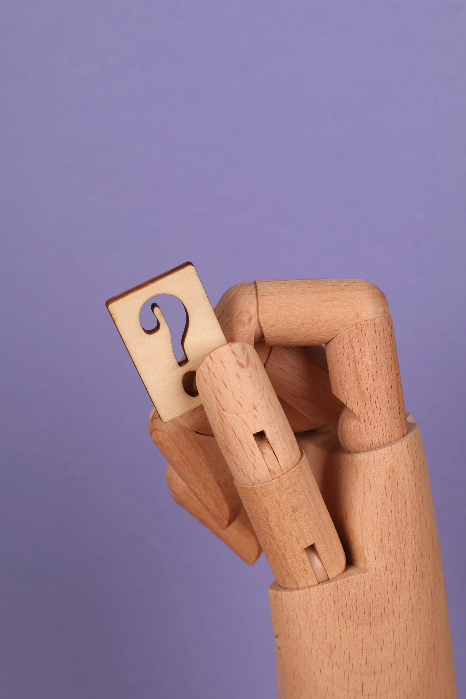 a wooden hand holding a piece of paper with a question mark on it, a surrealist sculpture, inspired by Grant Wood, unsplash, put on a mannequin, detailed product image, laser cut, toy design