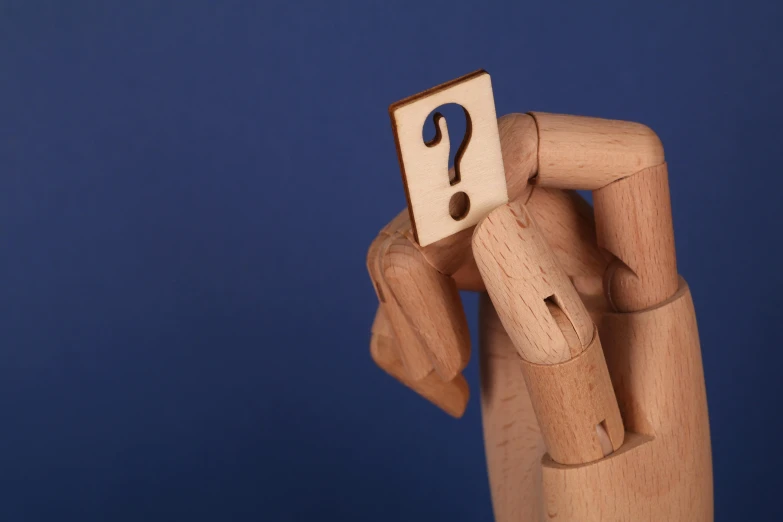 a person holding a wooden block with a question mark on it, unsplash, figuration libre, pop up parade figure, avatar image, prosthetic arm, close-up photo