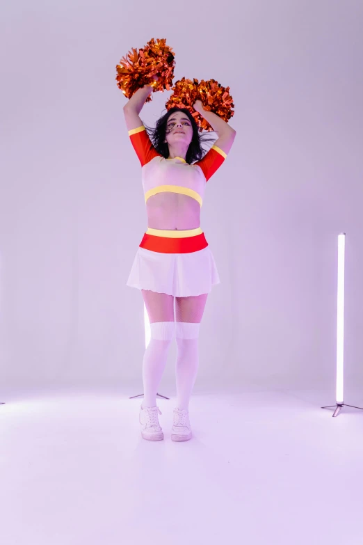 a woman in a cheerleader outfit holding pom poms, pexels, video art, orange lighting, in white room, ( ( theatrical ) ), pvc poseable