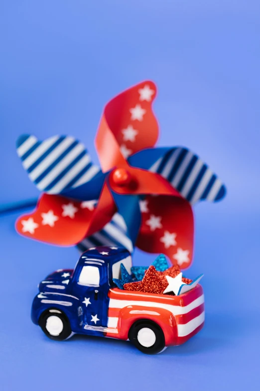 a toy truck with a red, white and blue pinwheel, by Nancy Graves, shutterstock contest winner, desk fan, polished : :, navy, photograph credit: ap