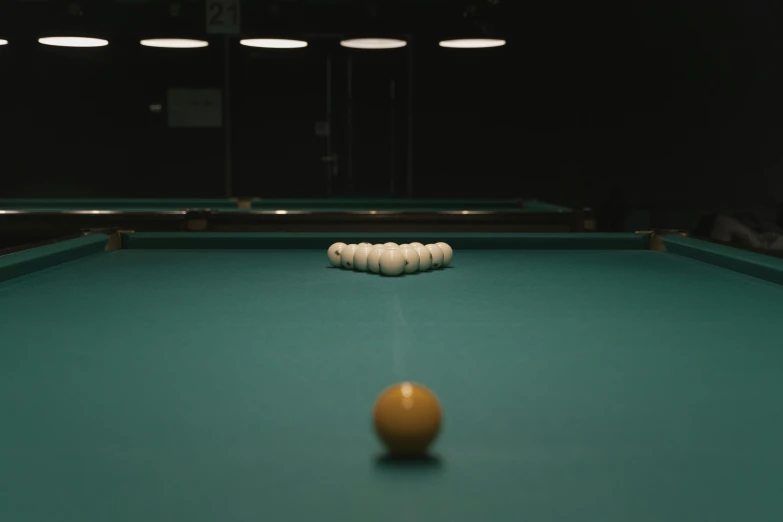 a pool table with a ball on it, by Elsa Bleda, unsplash contest winner, flashing lights, teal aesthetic, youtube thumbnail, in an arena pit