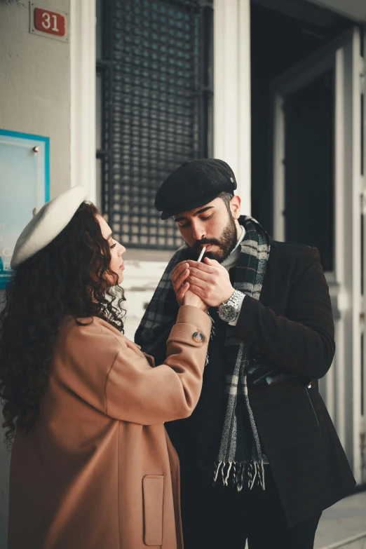 a man and a woman standing next to each other, by Lucia Peka, pexels contest winner, renaissance, holding a cigarette, wearing wool hat, making out, promotional image