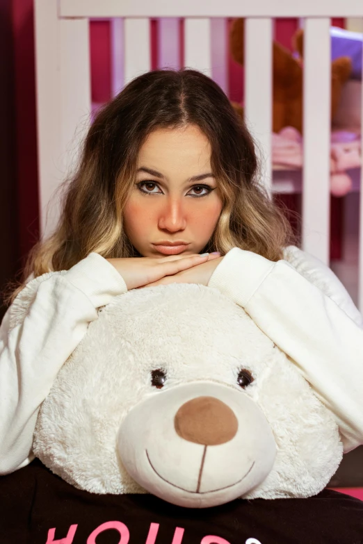 a woman sitting in front of a white teddy bear, an album cover, by Julia Pishtar, trending on pexels, pouty face, demur, serious, teenage