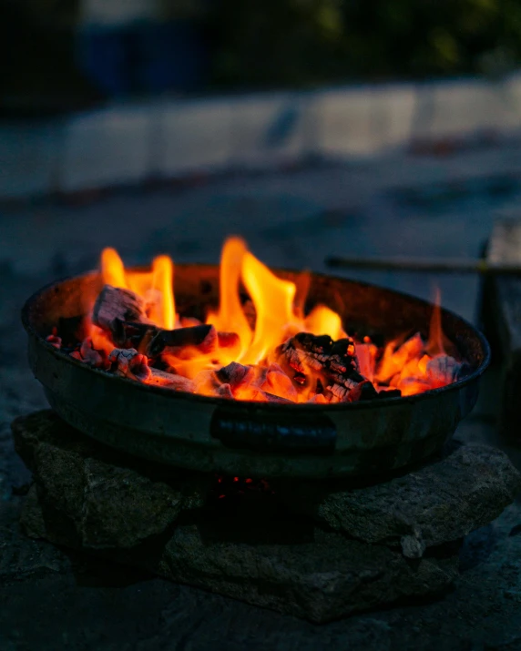 a close up of a fire in a grill, by Helen Stevenson, wooden bowl, glamping, cast iron material, instagram post