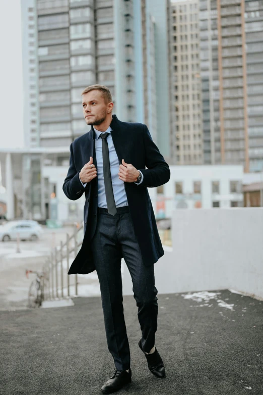a man in a suit and tie walking down a street, model posing, curated collections, anton fadeev 8 k, cold weather
