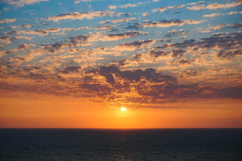 a view of the sun setting over the ocean, by Gwen Barnard, pexels contest winner, romanticism, partly cloudy sky, mediterranean, zoomed out, sunset panorama