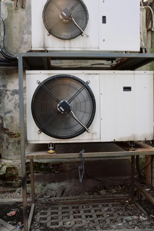 a couple of air conditioners sitting on top of each other, an album cover, by Attila Meszlenyi, unsplash, industrial machinery, circular gate in a white wall, old computer, low quality photo