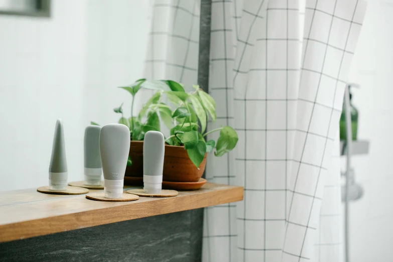 a couple of vases sitting on top of a wooden shelf, trending on pexels, under a shower, silicone skin, flat grey, miniature product photo