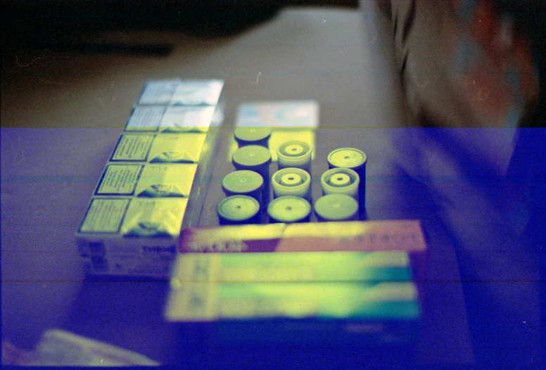 a pile of cigarettes sitting on top of a table, a hologram, flickr, holography, taken with kodak portra, pathology sample test tubes, her iridescent membranes, thermography