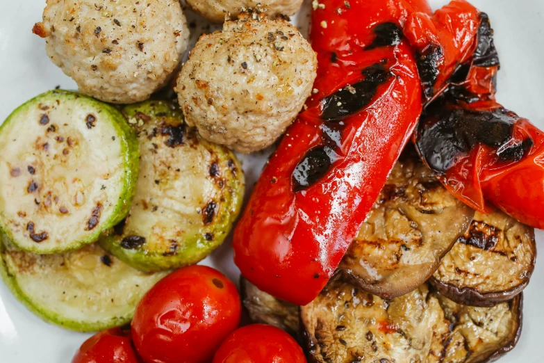 a white plate topped with grilled vegetables and meatballs, pexels, renaissance, background image, high texture detail, avatar image, thumbnail