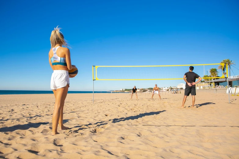 a group of people playing volleyball on a beach, avalon, profile image, blonde, 3 meters