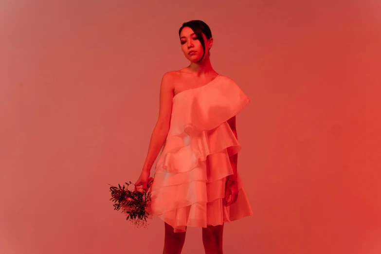 a woman in a pink dress holding a bouquet, an album cover, inspired by Elsa Bleda, unsplash, happening, white and red dresses, kiko mizuhara, ruffles, official store photo