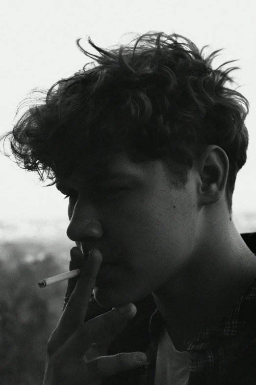 a black and white photo of a man smoking a cigarette, inspired by John Luke, curly and short top hair, cynthwave, profile picture, skies