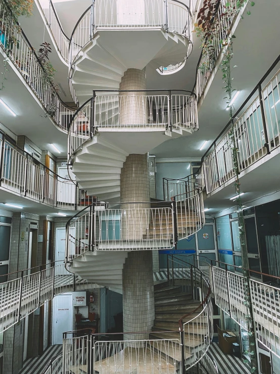 a spiral staircase in the middle of a building, inspired by Thomas Struth, unsplash, soviet apartment buildings, ultra realistic 8k octan photo, 2 5 6 x 2 5 6 pixels, reddit post