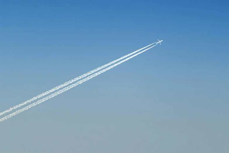 a couple of airplanes flying through a blue sky, by Matthias Weischer, plasticien, meteor, fast paced lines, profile image, chemistry