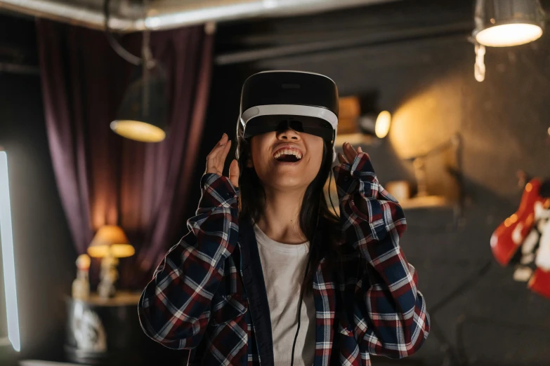 a woman wearing a virtual reality headset in a room, trending on pexels, head bent back in laughter, avatar image, holy grail, advertising photo