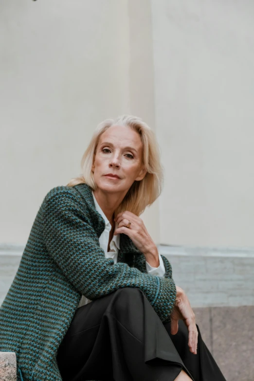 a woman sitting on the steps of a building, by Ivana Kobilca, wearing green jacket, white haired lady, standing elegantly, magdalena andersson