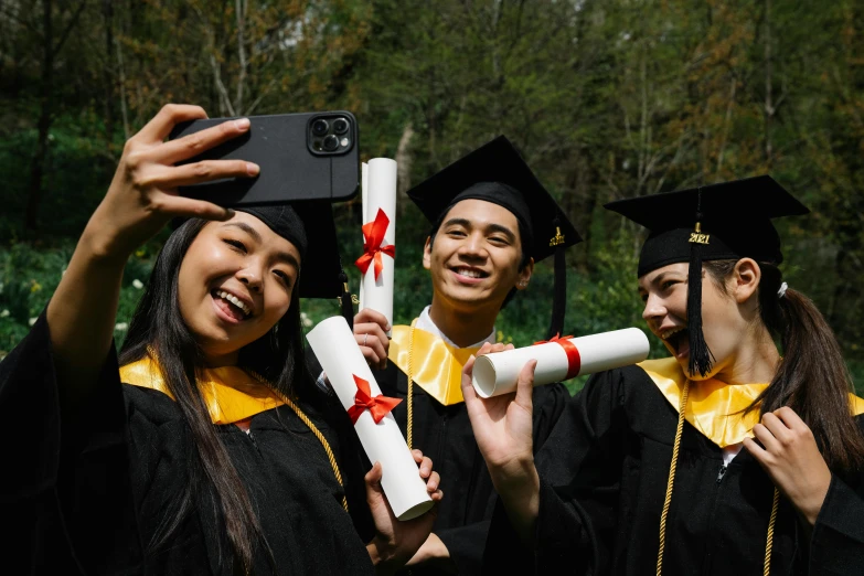 a group of people standing next to each other holding diplomas, a picture, by Julia Pishtar, shutterstock, academic art, taken on iphone 1 3 pro, asian descent, black, having a good time