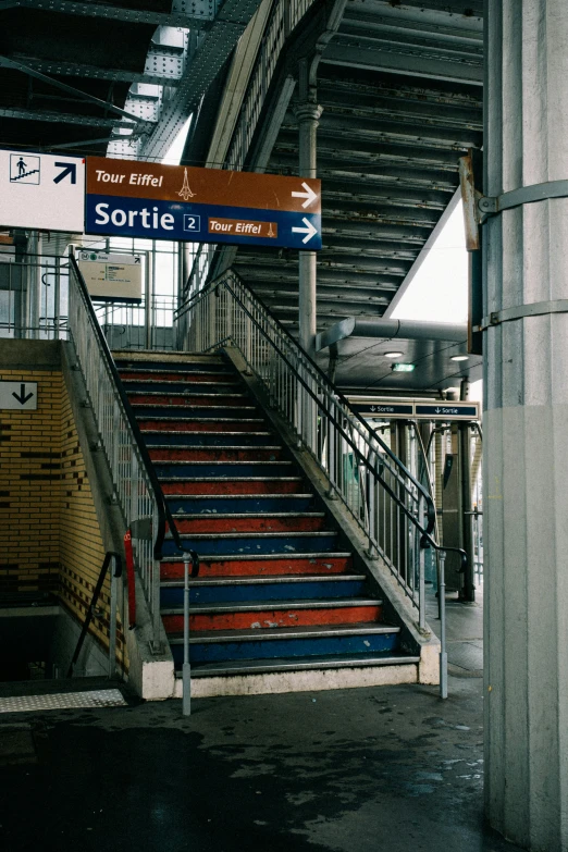 a train station with a bunch of stairs, sarenrae, lots de details, non-binary, sign