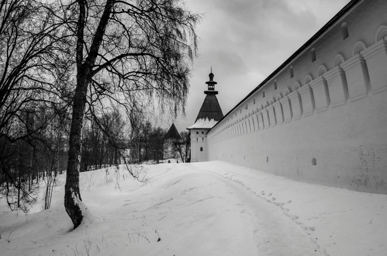 a black and white photo of a church in the snow, a black and white photo, by Serhii Vasylkivsky, pexels contest winner, visual art, wall wood fortress, dressed a long white, springtime, panorama