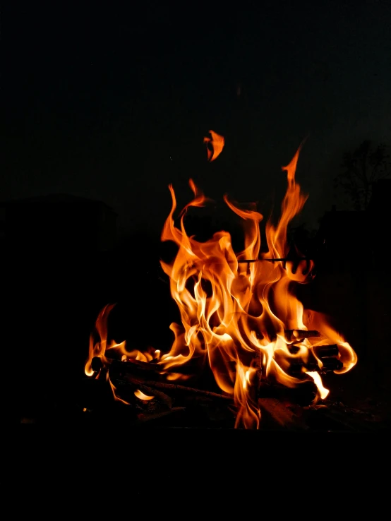 a close up of a fire in the dark, an album cover, by Jan Rustem, unsplash, s'mores, ignant, this is fine, 5 feet away