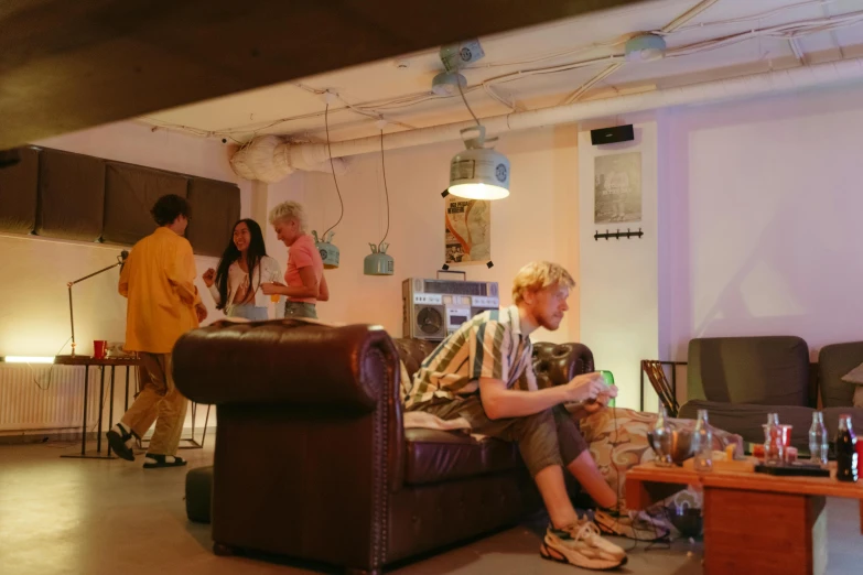 a couple of people that are sitting on a couch, unsplash, happening, underground lab, furniture around, shin jeongho, party atmosphere