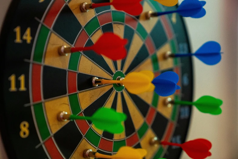 a close up of a dart in the center of a dart board, by Meredith Dillman, pexels contest winner, rainbow coloured rockets, board games on a table, 🦩🪐🐞👩🏻🦳, chess game