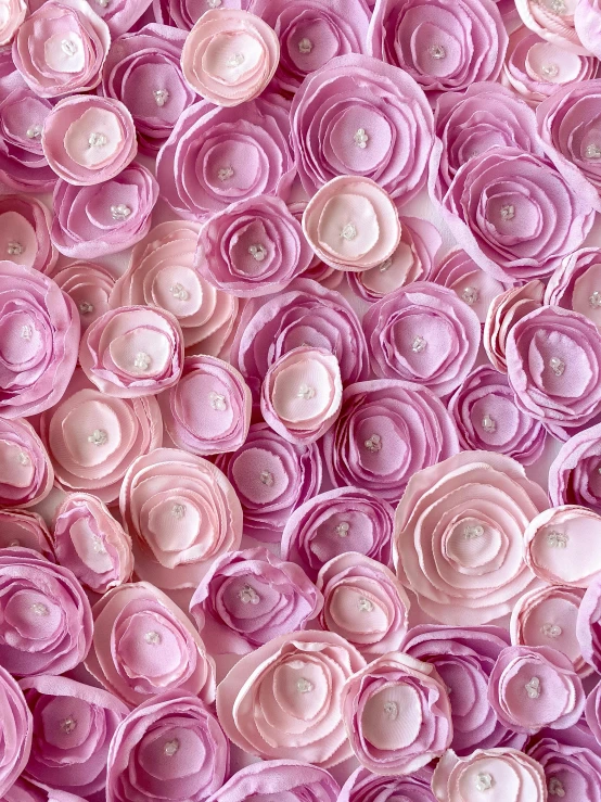 a close up of a bunch of pink flowers, by Lisa Milroy, process art, handcrafted paper background, 64x64, rose pink lighting, made of fabric