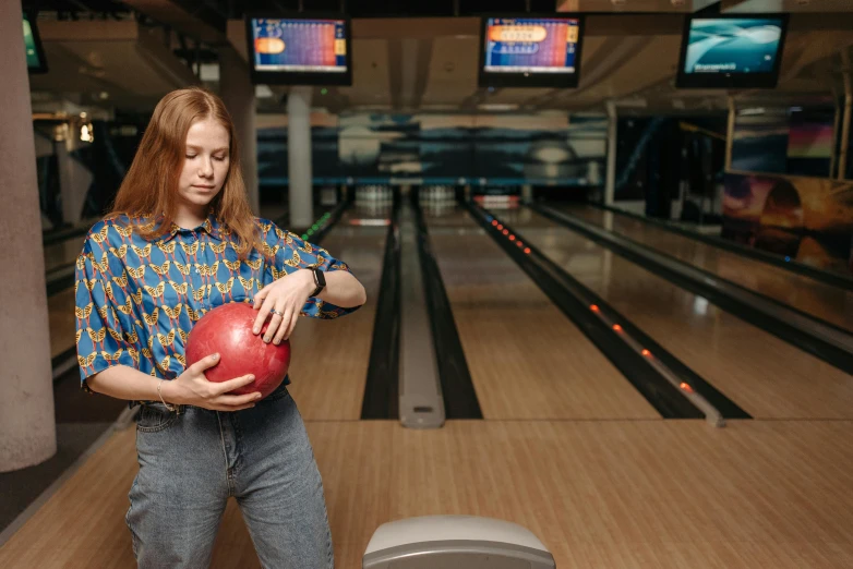 a woman holding a red bowling ball in a bowling alley, a portrait, by Julia Pishtar, pexels contest winner, renaissance, sadie sink, thumbnail, low quality photo, alexey gurylev