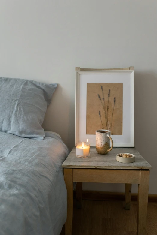 a bed room with a neatly made bed, inspired by Anna Ancher, featured on pinterest, on a candle holder, indigo, willowy frame, bespoke