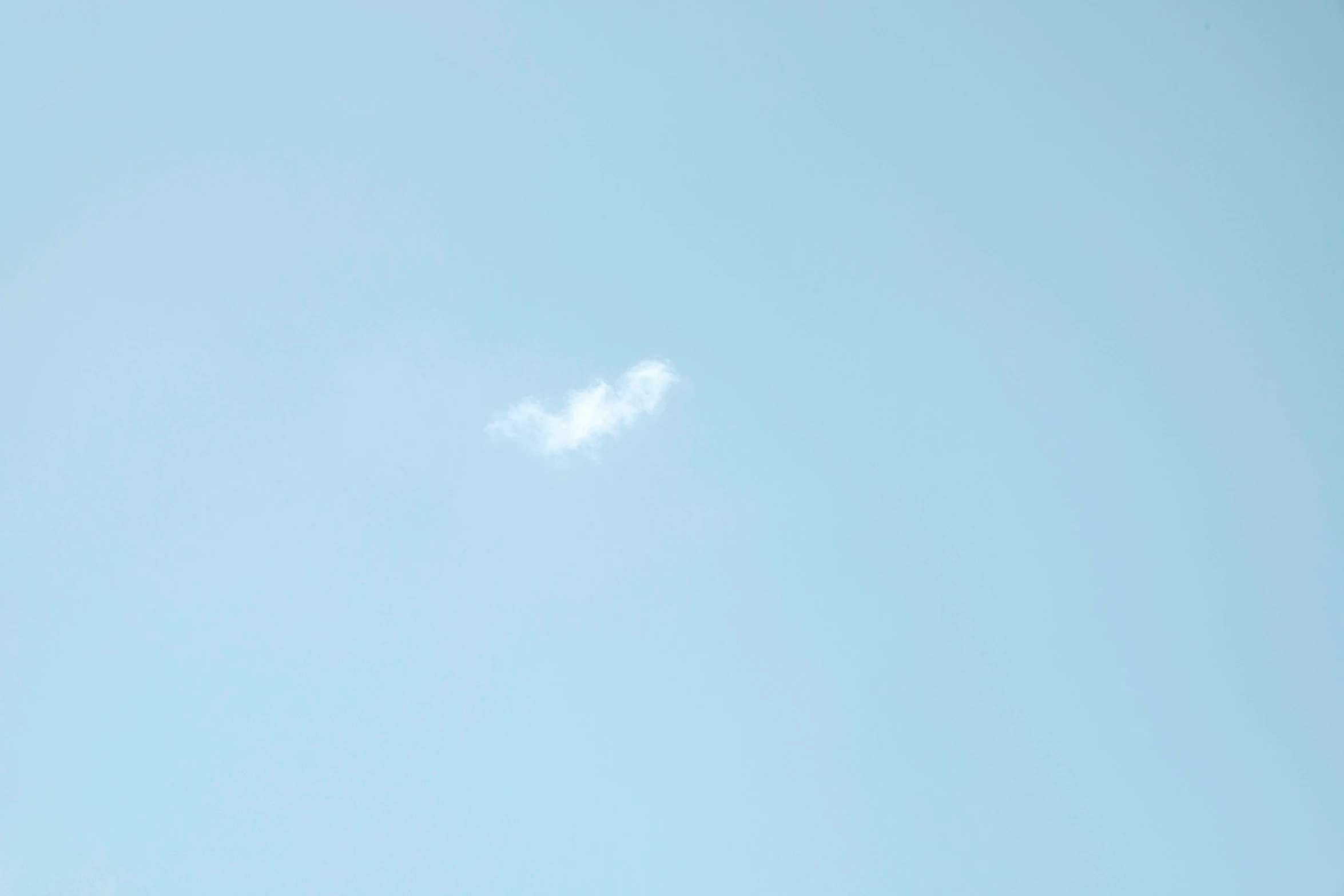 a plane that is flying in the sky, a minimalist painting, by Ai-Mitsu, white smoke, pareidolia, shot on sony a 7, comet