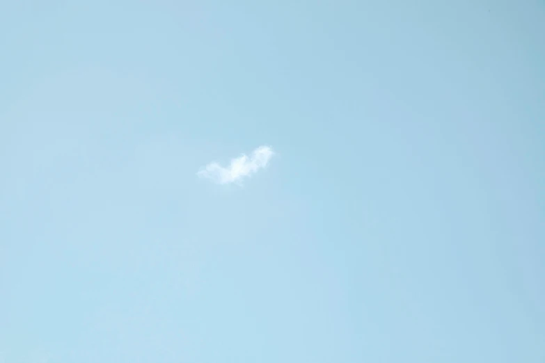 a plane that is flying in the sky, a minimalist painting, by Ai-Mitsu, white smoke, pareidolia, shot on sony a 7, comet