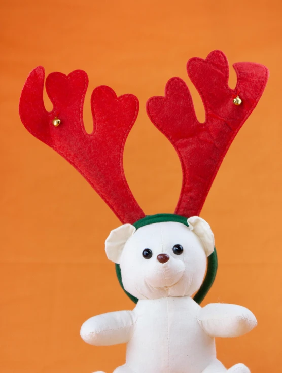 a white teddy bear with red antlers on its head, inspired by Rudolph F. Ingerle, happening, a brightly coloured, halo above head, official product photo, detail