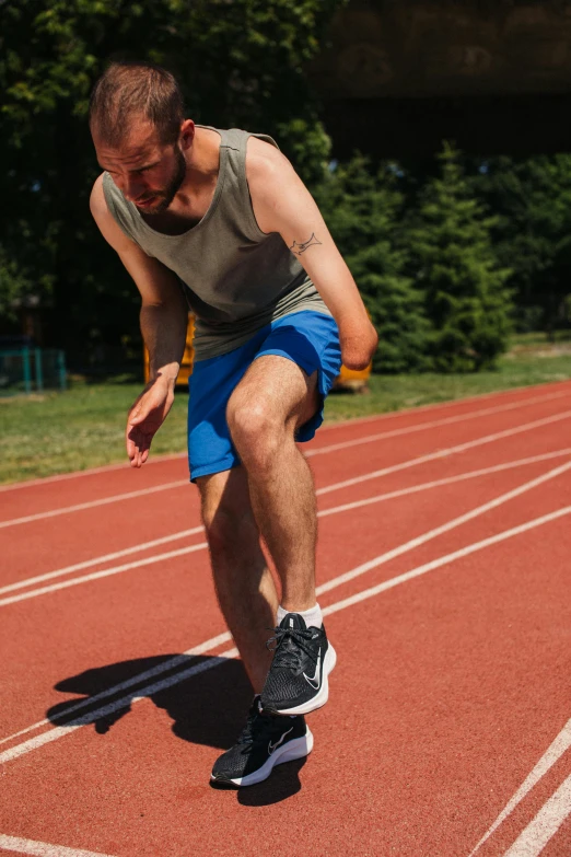 a man riding a skateboard on top of a track, in shorts, compression, thumbnail, working out in the field