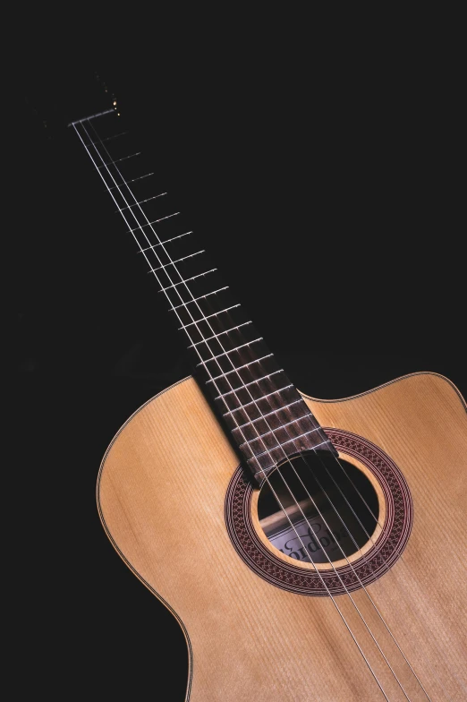 a close up of a guitar on a black background, an album cover, by Alejandro Obregón, taken in the 2000s, plain background, replica model, quintessa