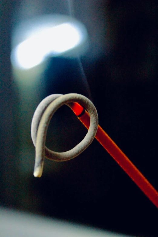 a pair of scissors sitting on top of a table, by Greg Rutkowski, plasticien, fire poi, ring flash closeup photograph, long hook nose, enso