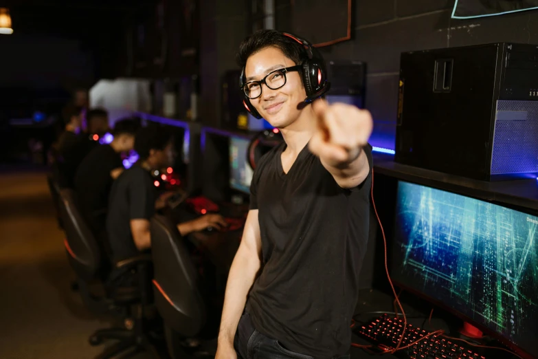 a man pointing at the camera while wearing headphones, sierra entertainment games, server in the middle, darren quach, mid shot portrait