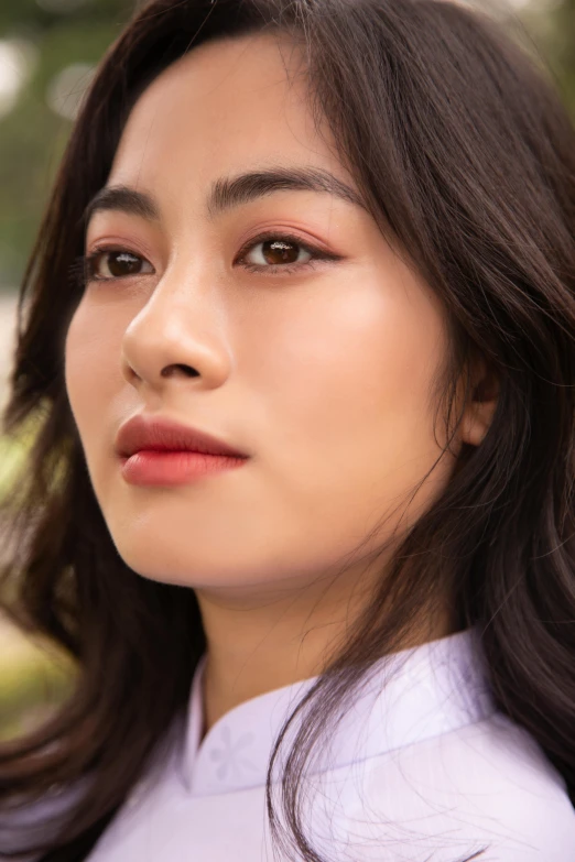 a woman with long hair wearing a white shirt, inspired by Zhang Yan, trending on pexels, beauty mark on cheek, south east asian with long, portrait closeup, peach