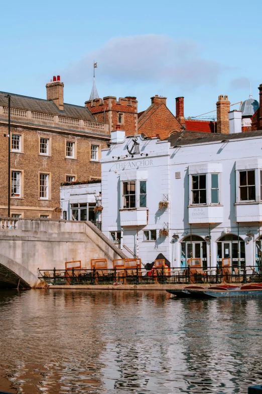 a bridge over a body of water with buildings in the background, inspired by Richmond Barthé, pexels contest winner, renaissance, whitewashed buildings, square, united kingdom, afternoon hangout